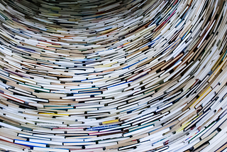 A tunnel made out of books is shown.