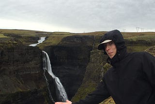 Photo of myself pretending to catch the water at the bottom of a waterfall