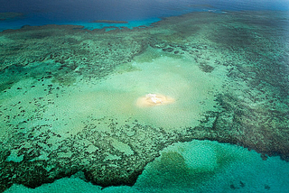 Small sand island in the middle of a coral reef, Australia