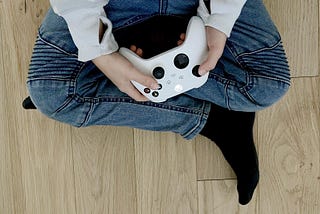 Picture of boy sitting holding a video game xBox controller