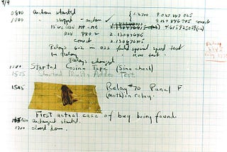Aged graph paper with handwritten markings, including a moth taped to it. Popularly, the “first computer bug”