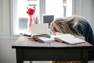 Frustrated recruiter with head on desk.
