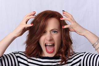 Red-haired woman losing her sh*t. (Hands thrown up in emotional dysregulation)