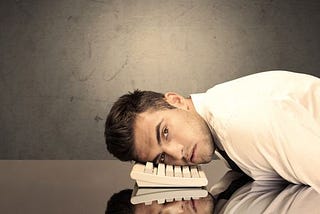 Man resting head on keyboard