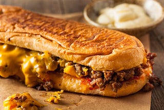 Homemade chop cheese sandwich with ground meat, American cheese, and ketchup.