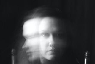 Black and white, multi-exposure, head shot, of a woman.