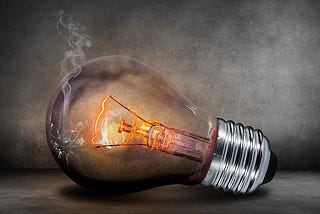 Light bulb lit with a burned housing