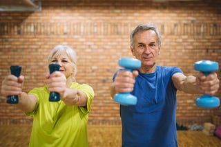 Seniors training with dumbbells