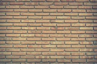 Brick wall as a metaphor for the building blocks of an action plan