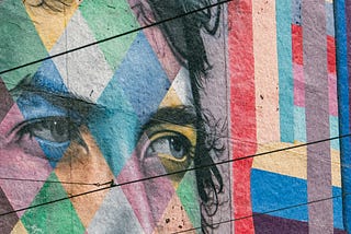 Mural of Bob Dylan on a side of a building. Photo courtesy of Unsplash and photographer Nikoloz Gachechiladze.