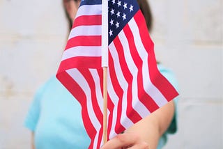 someone holding a small flag front and center