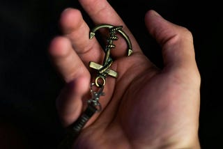 Unrecognizable man demonstrating anchor keychain on palm. Photo by Wallace Chuck via Pexels