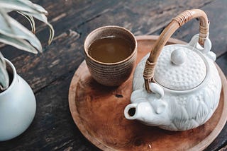 A Japanese-style teapot and a cup with a green tea