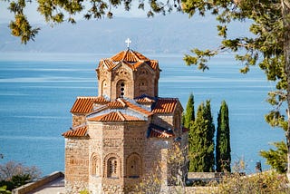 A historic church, sea in the background