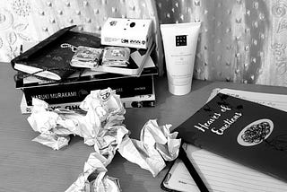 An image of books and crumbled papers on the table