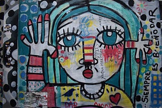 Abstract multi-colored artwork of a woman waving goodbye