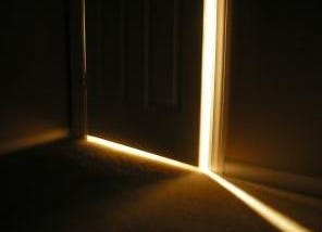 A cracked open door lets in a sliver of light