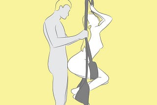 A girl hangs on a sex swing along with his standing man.