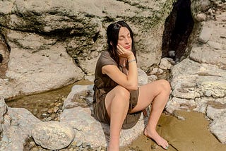 A young pregnant mother resting at the beach in the summer