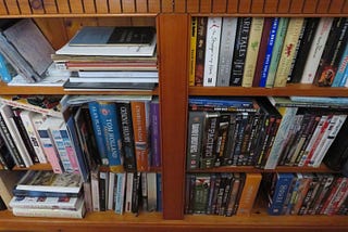 bookcase showing books and videos