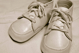 Baby shoes By JD Hancock from Austin, TX, United States. Cropped and edited by Daniel Case prior to upload — 1970 Baby Shoes