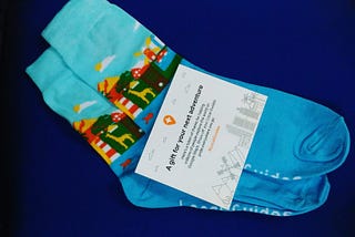 pair of blue socks on a dark blue background with a note