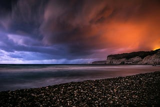a-storm-rolls-in-over-a-rocky-beach