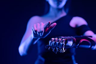 human pointing a finger with one hand, and the other being a robotic fist