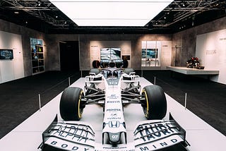 A white Formula 1 car on a raised platform at Formula 1 Exhibition. Soundscape by Coda to Coda