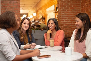 Diverse group of women meeting over coffee
