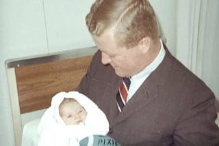 Old fashioned photo of a father holding his baby son