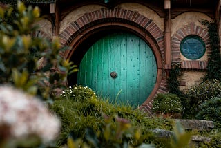 A cozy hobbit hole with a green door