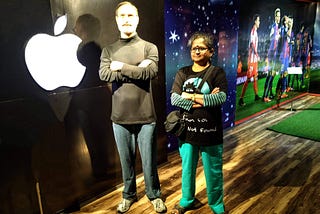 photo of woman in black tshirt posing with a wax figure of steve jobs at Johnnie’s Wax Museum, Shimla, India