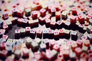 alphabet blocks of many colors spelling the word transgender