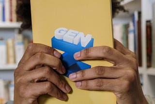 Woman holding a book that says ‘Gen Z’