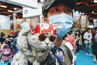 Man with cat on his shoulder at the Taipei Pet Show