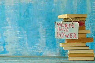 Stack of hardback books with words have power sign on blue background.Learning,education,reading,back to school concept.