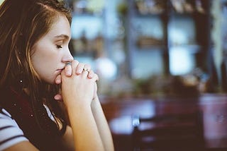 Photo of woman in deep thought and eyes closed