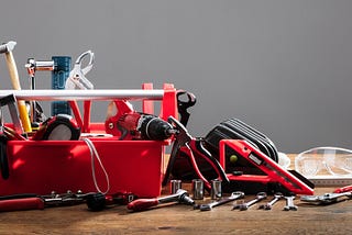 Various hand tools spread across a work surface.