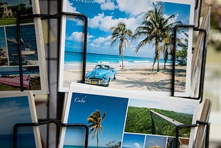 Postcards of exotic holiday destinations displayed on a rotating carousel