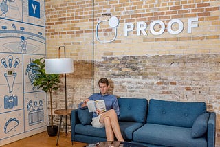 Man sitting on a couch with the word “proof” over his head in an article on Medium about SEO KPIs to track.