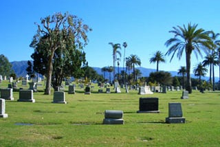 A picture of a cemetery on a beautiful day with a gorgeous blue sky in the background.