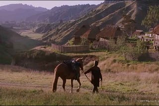 The final scene from the movie “The Last Samurai,” where the main character walks a horse toward a village.