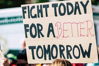 A protest sign on a climate march. The sign says: “Fight today for a better tomorrow”