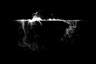 Mist spilling over edge of cup with dark background
