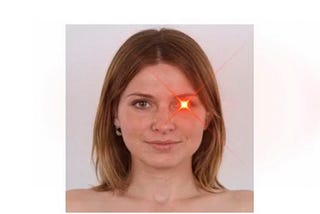 picture of a caucasian woman from the neck up. she is nude, light brown hair and there is a laser beam coming out of 1 eye