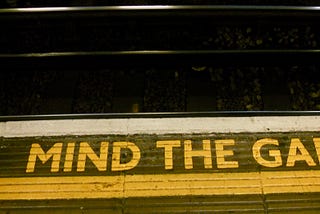 Image of a London Underground platform bearing the words “Mind the gap”