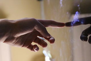 A hand touching a large digital display of some sort