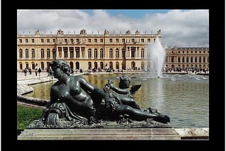 Picture of a statue in front of a fountain — château in the background.