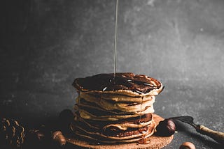 Syrup being drizzled onto pancakes
